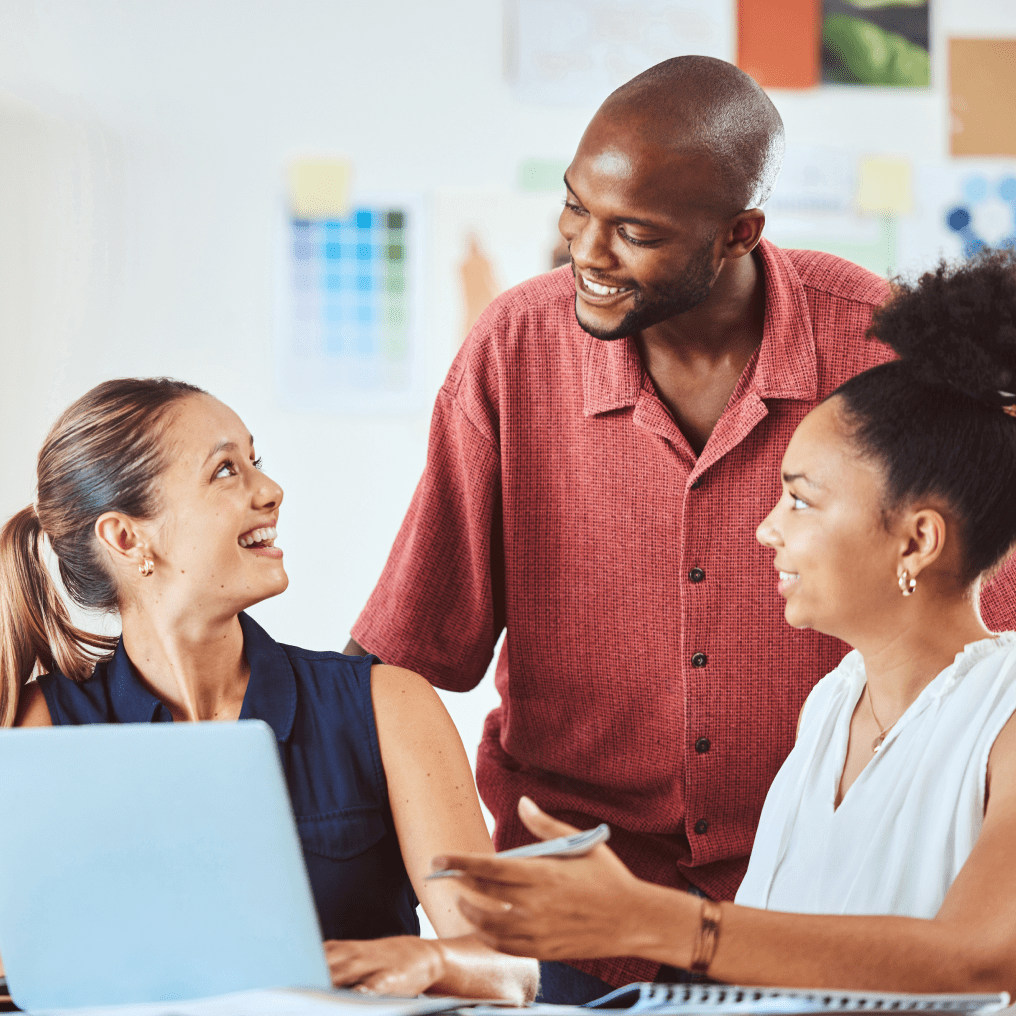 Young man having a friendly conversation with two women in a casual setting